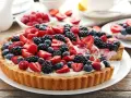 Pyszna tarta z mascarpone, obficie udekorowana świeżymi malinami, jeżynami, borówkami i truskawkami. Idealna na letnie popołudnie.