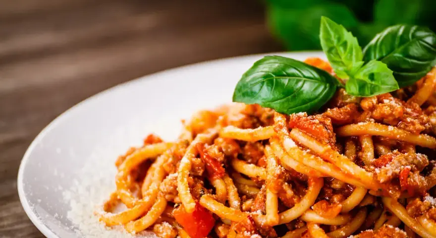 Pyszne spaghetti bolognese z mielonym mięsem, pomidorami i bazylią. Idealne pytanie: jakie mięso do spaghetti?